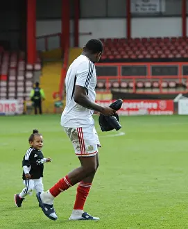 Bristol City V Crewe Prints: Bristol City's Jay Emmanuel-Thomas and Child: Celebrating Promotion at Ashton Gate