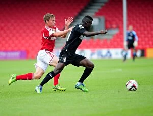 Images Dated 27th July 2013: Bristol City's Joe Bryan Closes In on Bournemouth's Mohamed Coulibaly during Pre-Season Friendly