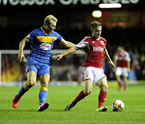 Images Dated 17th September 2013: Bristol City's Joe Bryan Fends Off Shrewsbury Town Opponent in League One Clash
