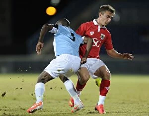Images Dated 24th July 2014: Bristol City's Joe Bryan Fights for the Ball in Botswana Tour Match against Botswana, 2014