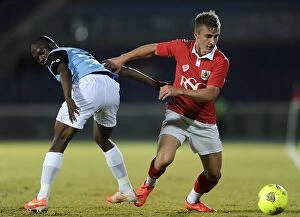 Images Dated 24th July 2014: Bristol City's Joe Bryan Fights for Possession in 2014 Botswana Tour Match