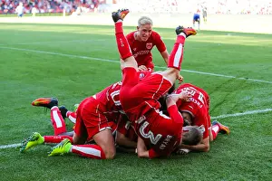 Bristol City's Joe Bryan Leaps Over Teammates as Bobby Reid Celebrates 2-1 Goal vs. Wigan Athletic
