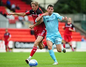 St Johnstone V Bristol City Prints: Bristol City's Jon Stead vs St Johnstone's Gary Miller - Football Rivalry at McDiarmid Park