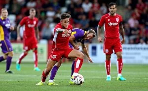 Images Dated 25th July 2016: Bristol City's Josh Brownhill Outmaneuvers Cheltenham Town's James Dayton in Preseason Friendly
