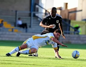 Images Dated 21st July 2010: Bristol Citys Kalifa Cisse battles for the ball with Torquays Elliot Benyon
