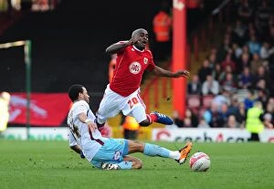 Images Dated 19th March 2011: Bristol City's Kalifa Cisse Fouled by Burnley's Tyrone Mears in Championship Match, 2011