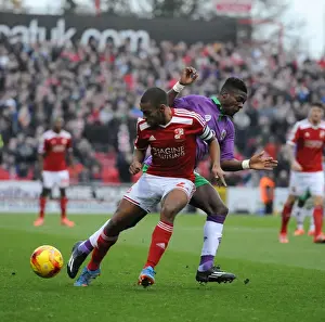 Bristol City's Kieran Agard Closes In on Swindon Town's Nathan Thompson in Sky Bet League One Clash