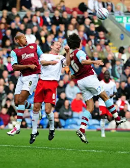 Burnley V Bristol City Prints: Bristol City's Louis Carey Battles for Aerial Ball Against Burnley's Iwelumo and Cork in Championship Match