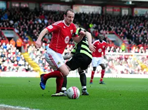 Bristol City's Louis Carey Outmaneuvers Joe Garner of Scunthorpe United in Championship Clash at Ashton Gate