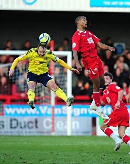 Images Dated 7th January 2012: Bristol City's Louis Carey vs. Tyrone Barnett: A Battle for the High Ball in FA Cup Match vs