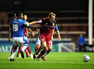Images Dated 18th September 2012: Bristol City's Martyn Woolford Outmaneuvers Peterborough United's Mark Little in Championship Clash