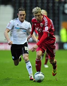 Derby County v Bristol City Collection: Bristol City's Martyn Woolford vs Ben Davies in Derby County Championship Clash - 10/12/2011