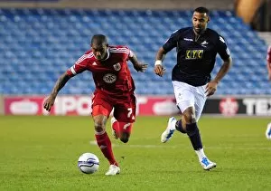 Images Dated 12th April 2011: Bristol City's Marvin Elliott Outmaneuvers Millwall's Liam Trotter in Championship Clash