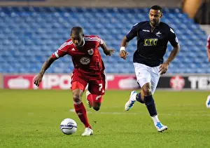 Millwall V Bristol City Prints: Bristol City's Marvin Elliott Outmaneuvers Millwall's Liam Trotter in Championship Clash