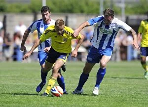 Images Dated 6th July 2013: Bristol City's Rhys Jordan Fights for Possession Against Clevedon Town Defense in Pre-Season