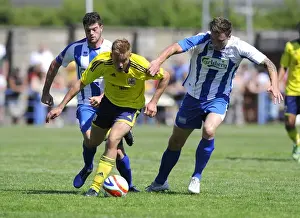 Bristol City's Rhys Jordan Fights for Possession Against Clevedon Town Defense in Pre-Season Friendly