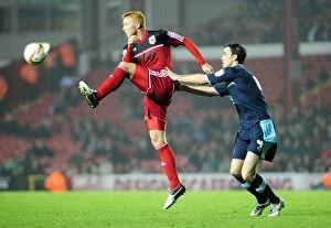 Images Dated 23rd October 2012: Bristol City's Ryan Taylor Outmuscles Burnley's Michael Duff for the Ball in Championship Clash at