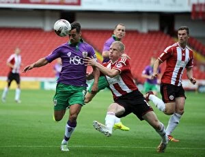 Images Dated 9th August 2014: Bristol City's Sam Baldock Faces Off Against Sheffield United's Craig Alcock in League One Opener