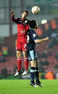 Images Dated 23rd October 2012: Bristol City's Sam Baldock Outjumps Burnley's Brian Stock for a Header in Championship Match