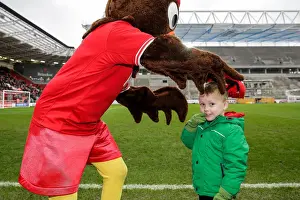 Bristol City V Ipswich Town Prints: Bristol City's Scrumpy Mascot Delights Young Fan with Cap Presentation at Half-Time