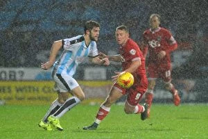Images Dated 12th December 2015: Bristol City's Simon Cox Closes In on Huddersfield Ball in Championship Clash