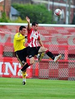 Images Dated 26th July 2010: Bristol City's Stephen Henderson Clears Under Pressure Against Exeter City