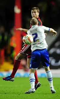 Framed Print : Bristol City's Steven Davies Battles for Header Against Millwall's Alan Dunne in Championship Match Framed Print : Bristol City's Steven Davies Battles for Header Against Millwall's Alan Dunne in Championship Match