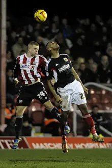 Brentford V Bristol City Prints: Bristol City's Tyrone Barnett Battles Jake Bidwell in Aerial Clash at Griffin Park