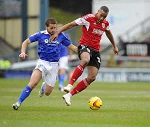 Images Dated 8th February 2014: Bristol City's Tyrone Barnett vs Oldham Athletic's James Wesolowski