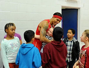 Images Dated 11th October 2014: Bristol Flyers Basketball: Greg Streete Embraces Young Fan Amidst Cheers at Wise Campus