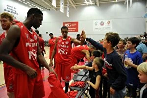 Images Dated 11th October 2014: Bristol Flyers Doug Herring and Excited Fan Celebrate in British Basketball Cup Match