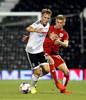 Images Dated 21st September 2016: Cauley Woodrow vs Taylor Moore: A Battle at Craven Cottage - Fulham vs Bristol City EFL Cup Clash