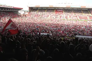 Celebrating Promotion: Thrilled Fans Invade the Pitch at Bristol City Football Club