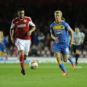 Chasing the Win: Intense Moment as Curtis Main of Shrewsbury Town Pursues Derrick Williams of Bristol City