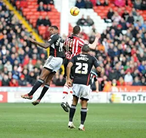 Images Dated 22nd February 2014: Clash at Bramall Lane: Jay Emmanuel-Thomas Battles Neil Collins for Aerial Supremacy in Sheffield