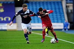 Images Dated 1st January 2013: Clash at The Den: Millwall's James Henry Pressures Bristol City's Gregg Cunningham