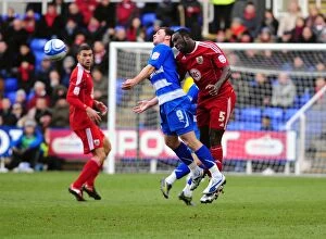 Images Dated 26th December 2010: Damion Stewart Leaps Over Shane Long: A Championship Battle at Reading's Madejski Stadium