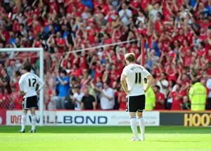 Dejected Bristol City Players as Nottingham Forest Celebrate Championship Victory