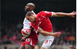 Dele Adebola jumps with Joel Lynch