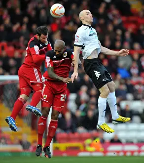 Bristol City V Derby County Prints: Derby County's Conor Sammon Leaps Above Bristol City's Marvin Elliott and Richard Foster