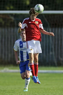Bristol City U18s v Brighton U18s Collection: Determined Tom Fry Heads the Ball for Bristol City U18 against Brighton & Hove Albion U18