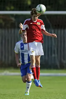 Development Prints: Determined Tom Fry Heads the Ball for Bristol City U18 against Brighton & Hove Albion U18