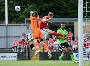 Images Dated 20th July 2013: Forest Green Rovers Sam Russell Clears from Steven Davis in Preseason Clash vs. Bristol City