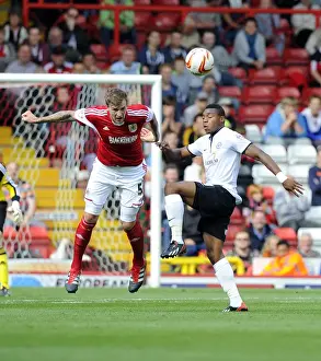 Bristol City V Peterborough Prints: Intense Aerial Battle: Flint vs Assombalonga - Football Rivalry in the Sky