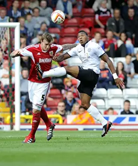 Bristol City V Peterborough Prints: Intense Aerial Battle: Flint vs Assombalonga - Football Rivalry in the Sky (Bristol City vs Peterborough)