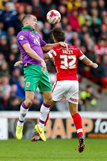 Images Dated 25th October 2014: Intense Aerial Clash: Wilbraham vs Bailey at Barnsley's Oakwell Stadium