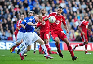 Cardiff City v Bristol City Collection: Intense Rivalry: Burke vs. Caulker in the Npower Championship Clash at Cardiff City Stadium