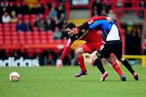 Images Dated 23rd February 2013: Intense Rivalry: Cunningham vs. O'Brien's Battle for Ball Possession, Bristol City vs. Barnsley