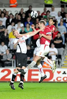 Jamie McCombe and Alvaro Saborio pressure the Swansea defence