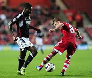 Framed Print : Jay Emmanuel-Thomas of Bristol City Passes Past Steven Davis of Southampton during Capital One Cup Match Framed Print : Jay Emmanuel-Thomas of Bristol City Passes Past Steven Davis of Southampton during Capital One Cup Match